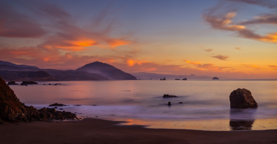 Seascape of Port Orford in Oregon with Humbug Mountain at sunset