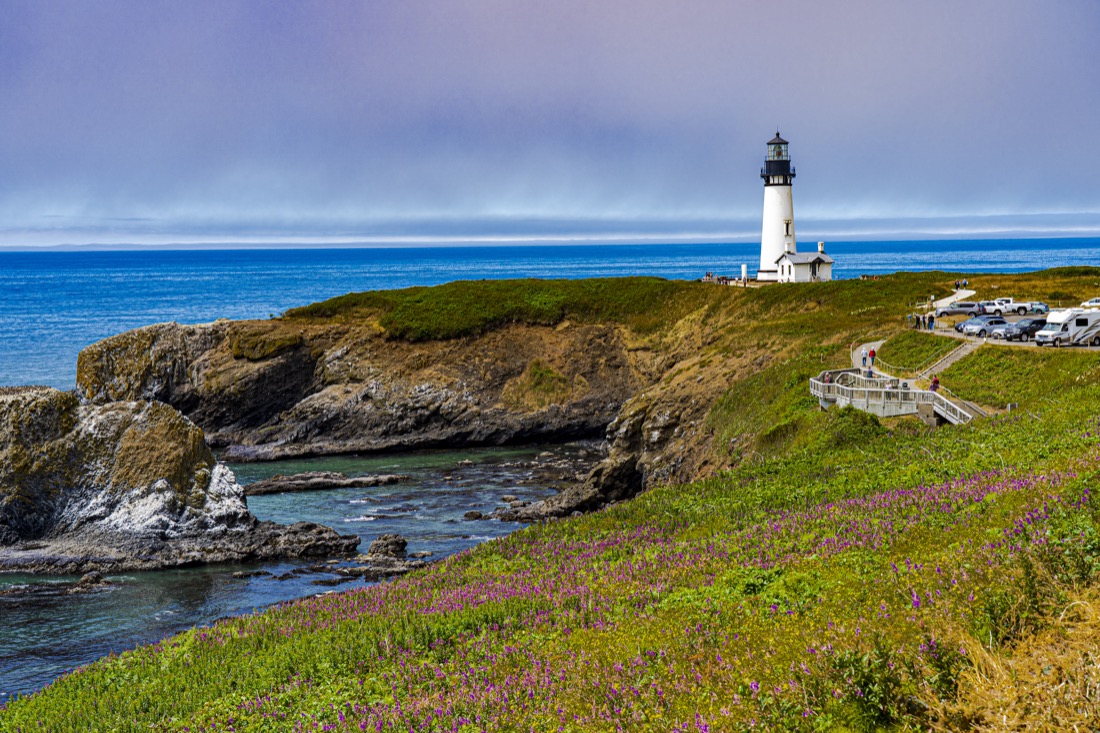 Blue skies, green cliffs and Yaquina Bay Lighthouse