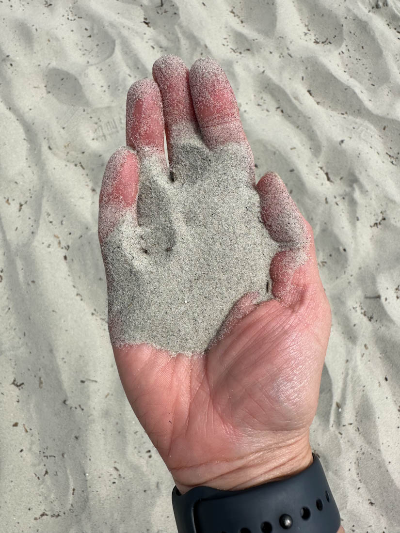 Hand holding sand on Hand Coligny Beach Hilton Head 