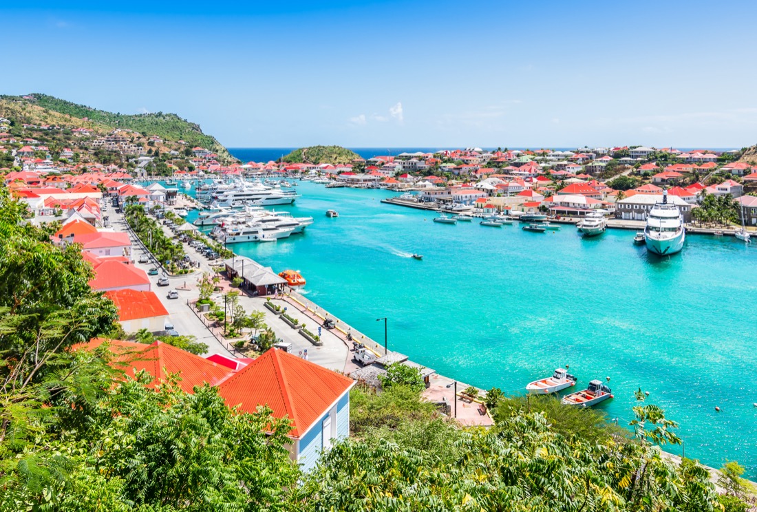 Striking turquoise ocean surrounded by buildings and boats at Gustavia Harbor in St Barts 