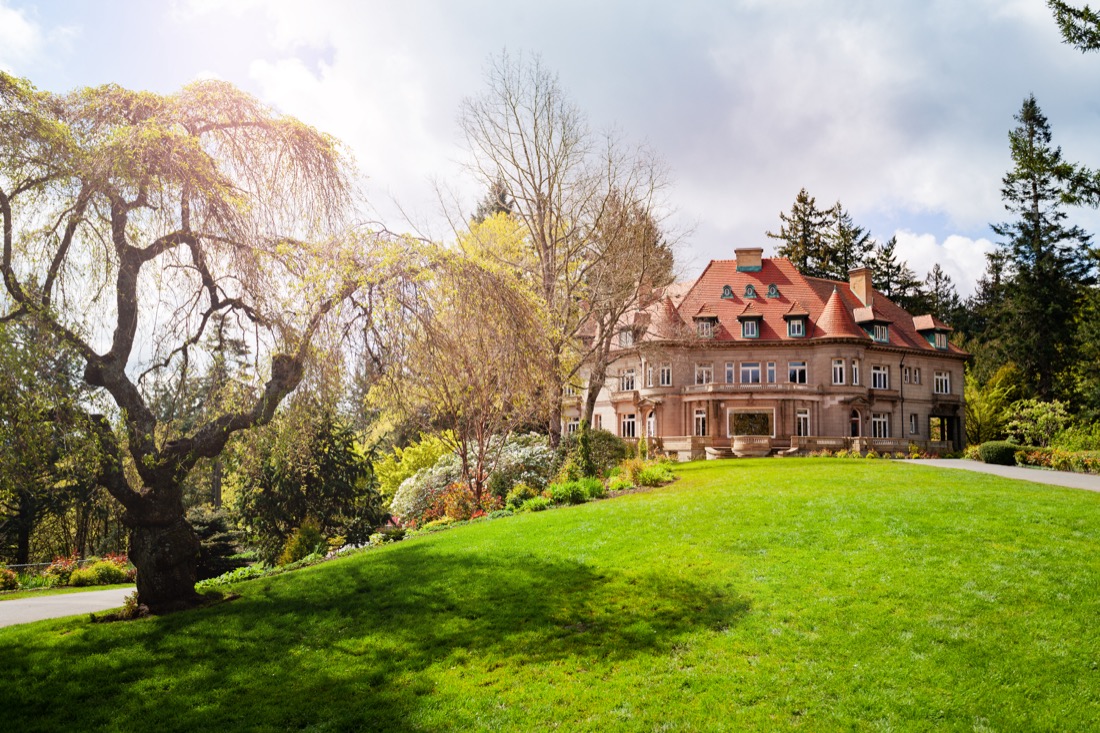 Sunny day at Pittock Mansion museum with trees, Portland, Oregon