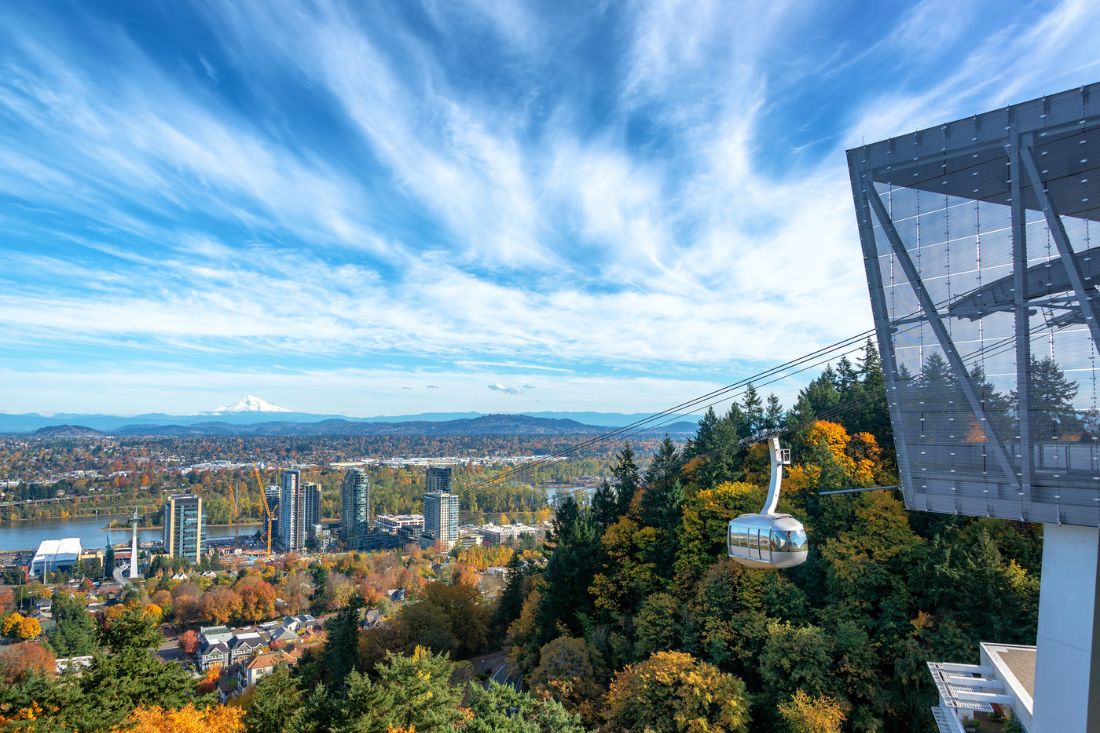 Photo of an aerial tram and scenic view of Portland, OR in the fall