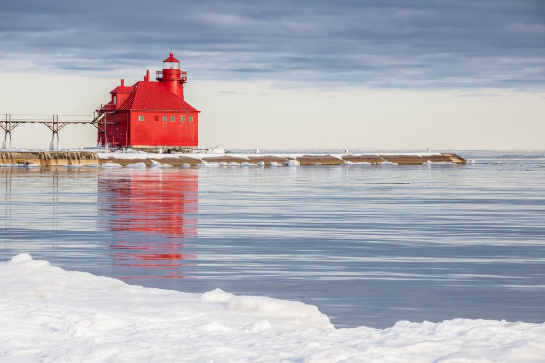 Red Lighthouse in a lake in winter in Sturgeon Bay, WI