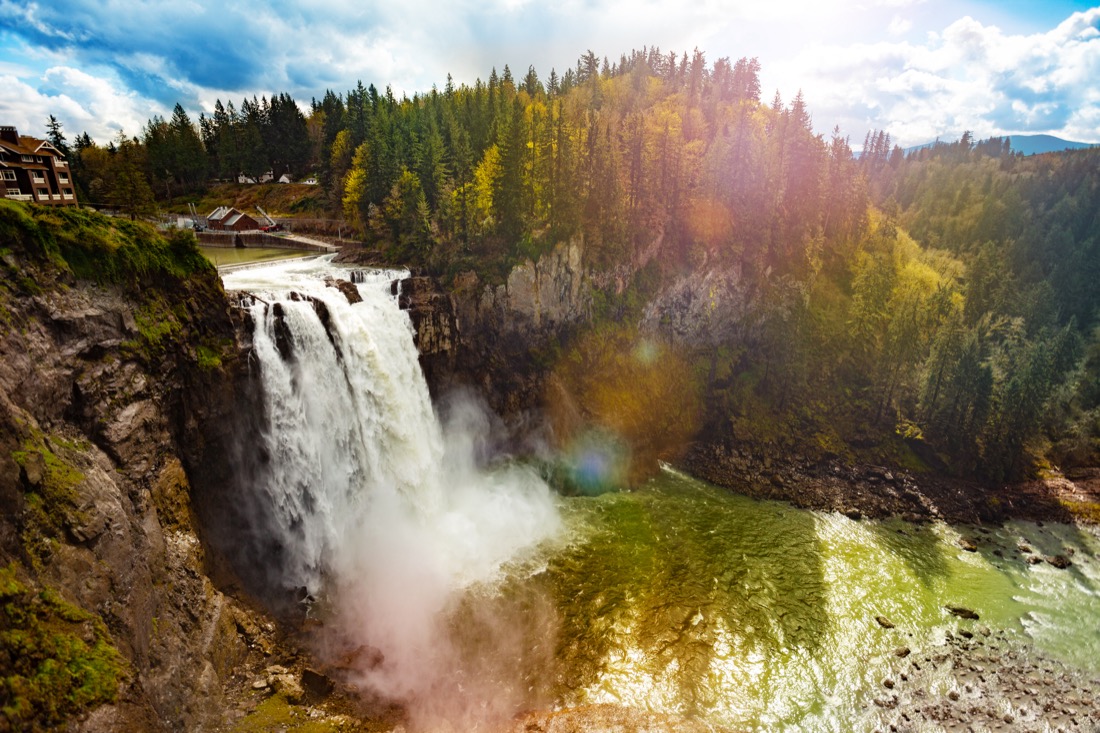 Flowing Snoqualmie Falls with slight fall colors surrounding