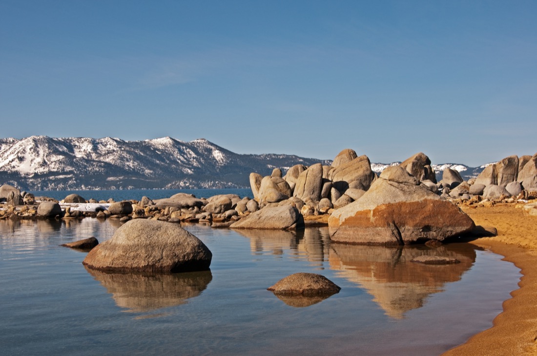 Big rocks and snowy mountains at vZephyr Cove, Lake Tahoe