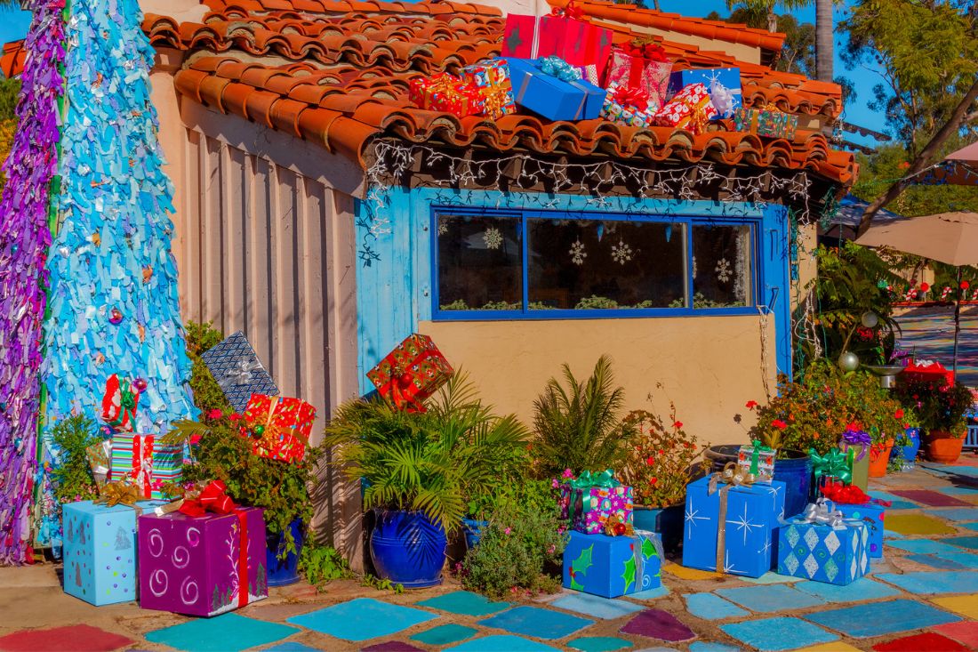 Small House with gift boxes and holiday tree in Spanish Village Art Center, San Diego, California