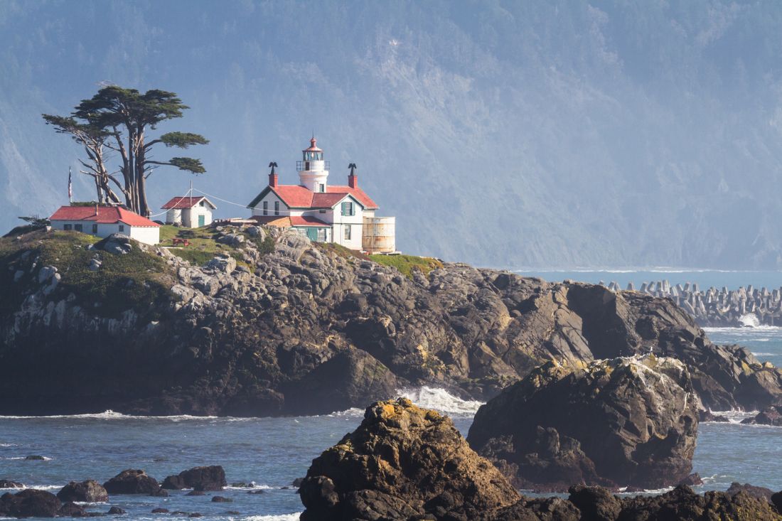 Lighthouse on a small island off the shore at Crescent City, California.