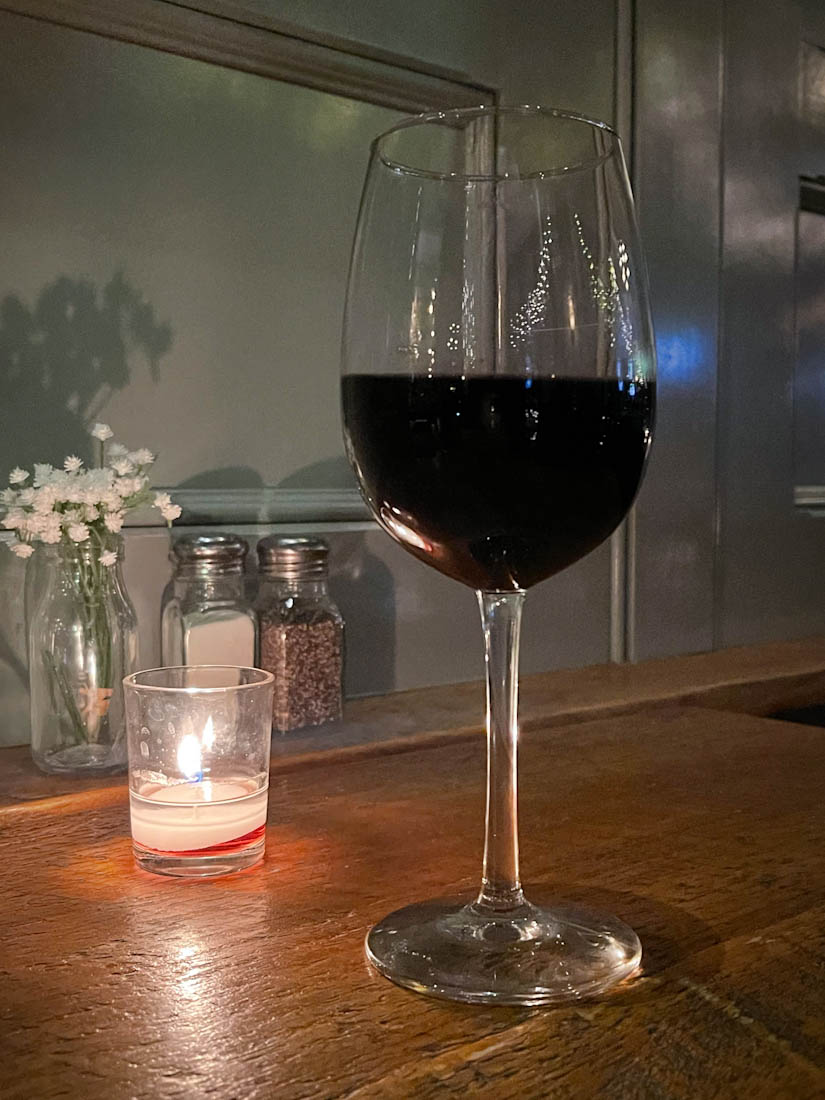 Glass of red wine on table
