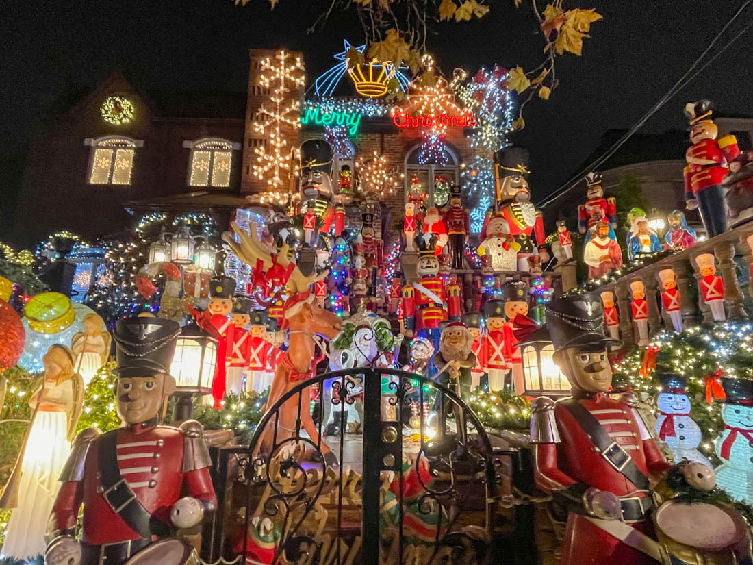 Spata House at Dyker Heights Brooklyn all lit up with lights and decorated with toy soldiers, snowmen, and angels