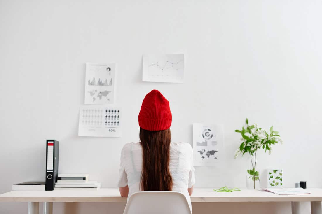 Red hat woman at desk.