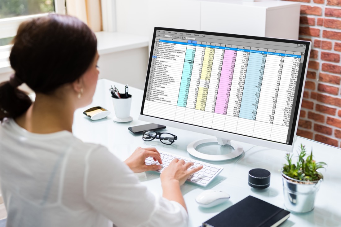 Woman using spreadsheet on desktop. Office. 