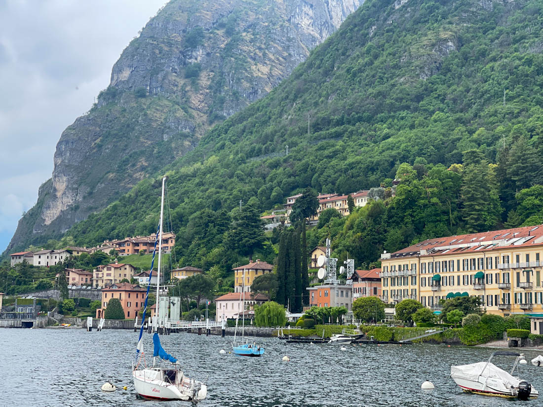Boat in water at Menaggio with alps in background Lake Como Italy