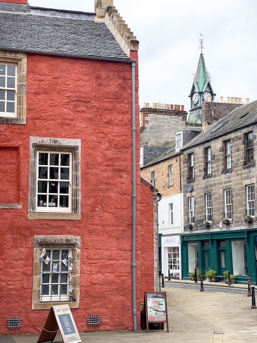 Red building of Abbot House with City Chambers Clock in Dunfermline Fife