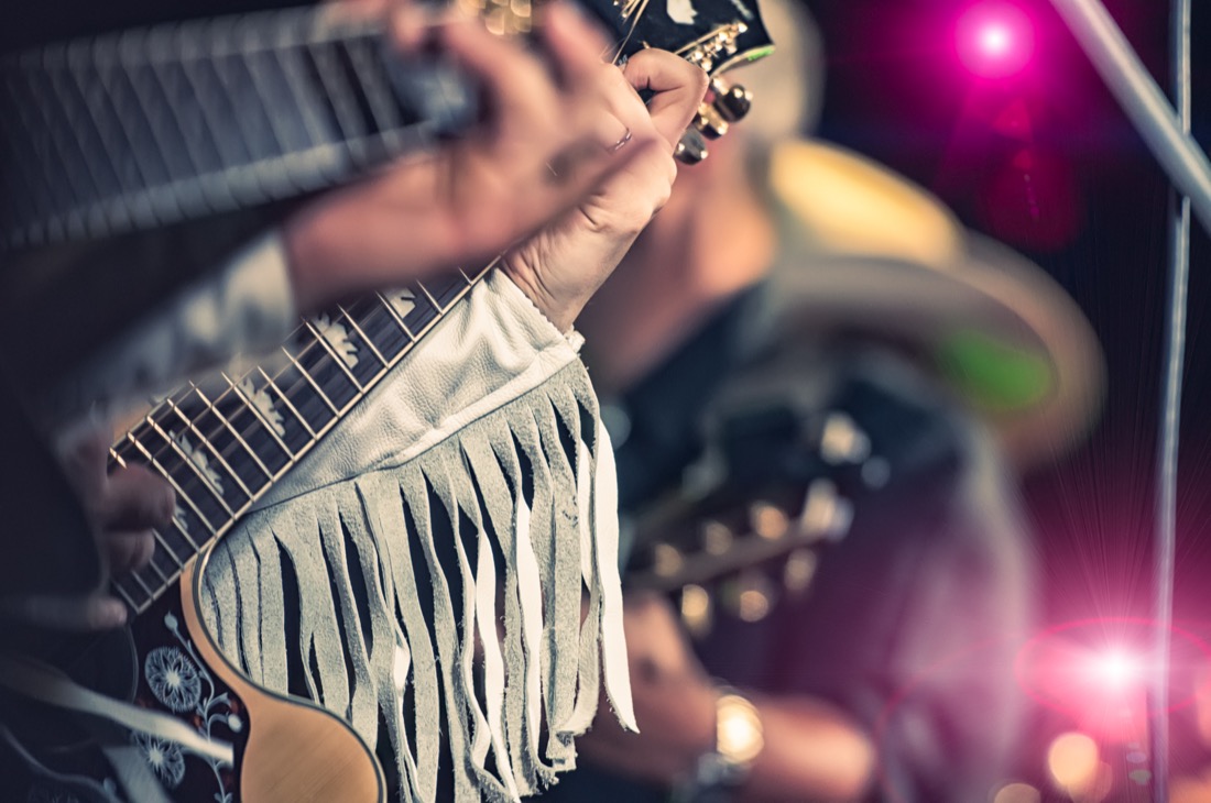 Country band playing guitar with fringed top